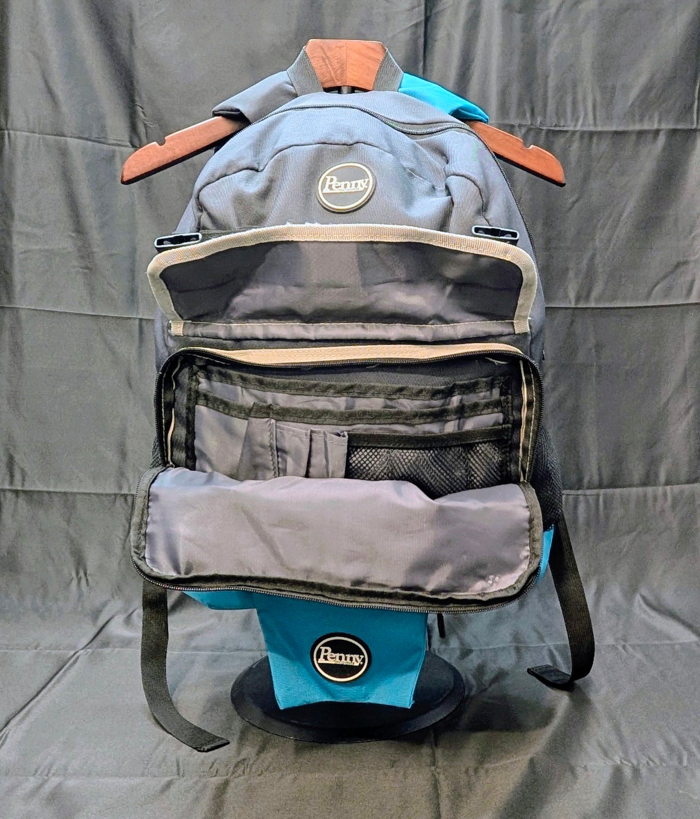 Gray backpack with visible brand logo on a gray background
