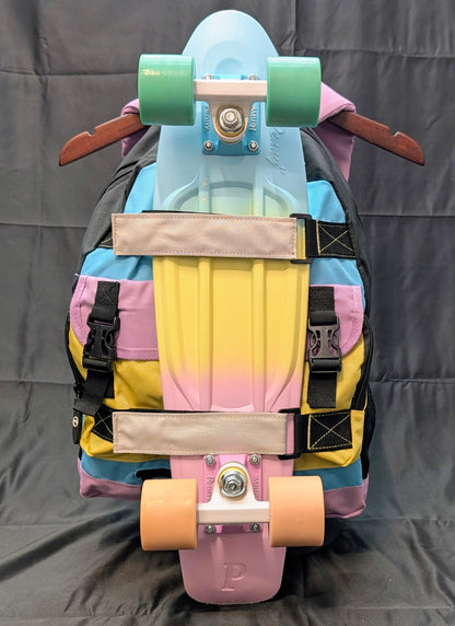 Colorful skateboard with a backpack on a gray background