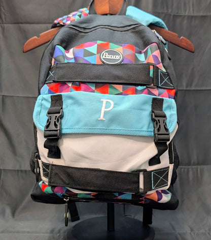 Multicolored backpack with geometric pattern on a gray background