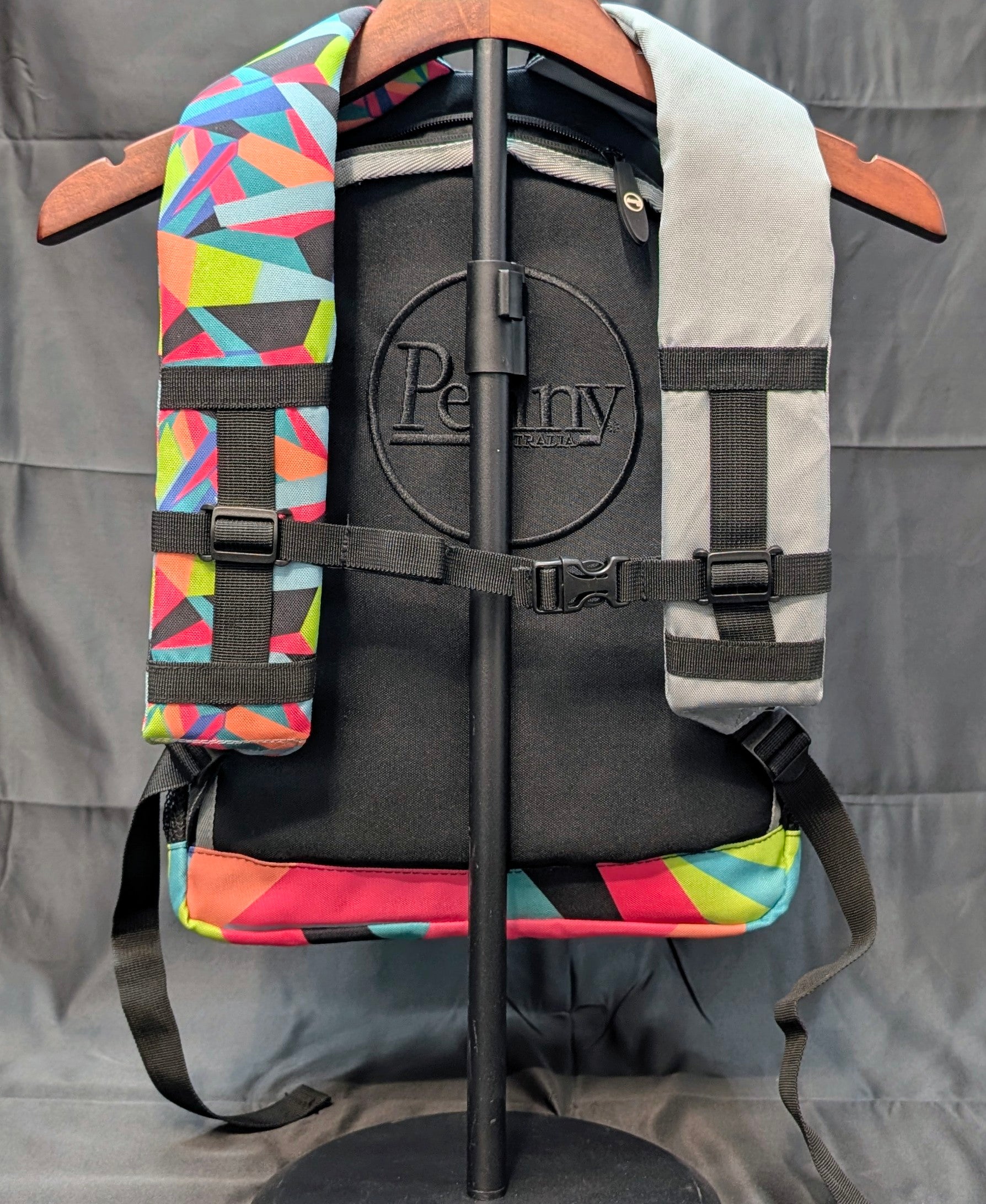 Black backpack with colorful geometric patterns on a gray background